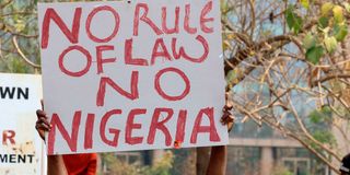 Nigerian holding a banner