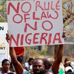 Nigerian holding a banner