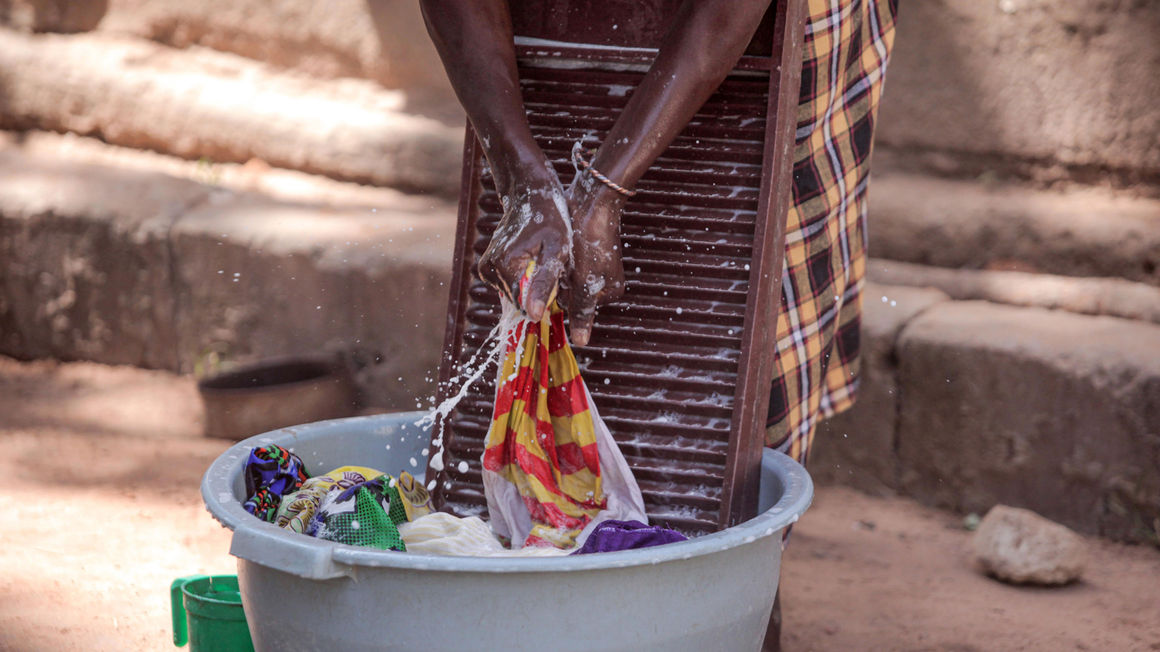 A domestic worker washing clothes