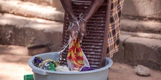 A domestic worker washing clothes