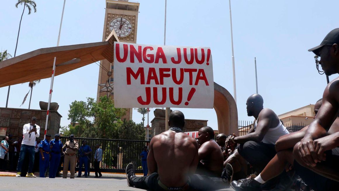 A group of Kenyans protest outside Parliament