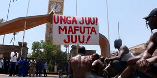 A group of Kenyans protest outside Parliament