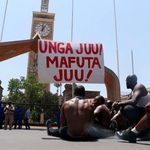 A group of Kenyans protest outside Parliament