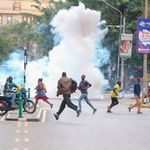 People run for cover after police threw tear gas 