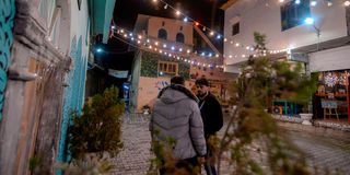 Iraqis stand at a renovated area in Mosul