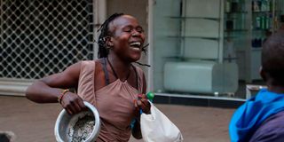 A woman holding a cooking pot during protest