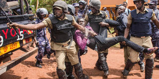 Police arrest a supporter of Uganda's Bobi Wine.