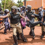 Police arrest a supporter of Uganda's Bobi Wine.