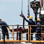 Workers at a crude oil extraction plant in Colombia.