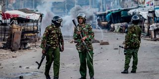 Kenyan police officers patrol a street in Nairobi