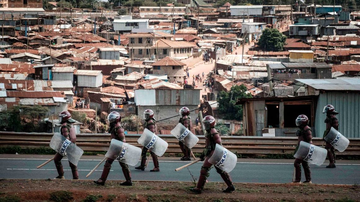 Kenyan anti-riot police officers patrol in Kibera