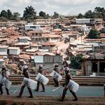 Kenyan anti-riot police officers patrol in Kibera
