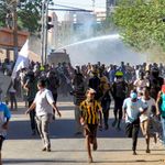 Demonstrators flee from ant-riot police in Sudan.