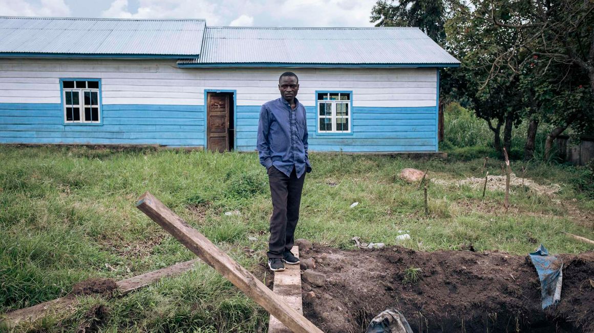 A man stands next to a hole in Kishishe