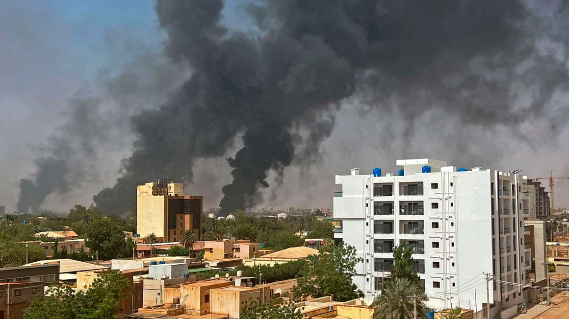 Smoke billows above residential buildings in Khartoum