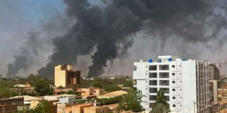 Smoke billows above residential buildings in Khartoum