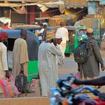 Men walk along a street in Khartoum's twin city of Umdurman 