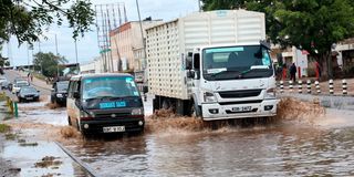 Vehicles drive through floods in Nairobi, Kenya