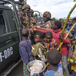 Kenyan soldiers with residents of Kiruma in DR Congo