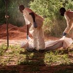 Workers carry a body bag to the mortuary from Shakahola
