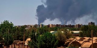 Smoke billows over buildings in Khartoum on May 1, 2023