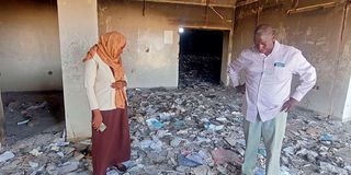 People inspect a destroyed medical storage in Nyala, Darfur.