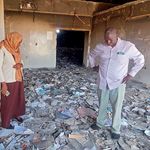 People inspect a destroyed medical storage in Nyala, Darfur.