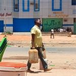 A man carries fuel containers in southern Khartoum