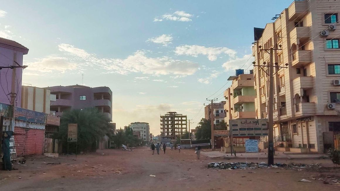 People walk on a street in southern Khartoum 