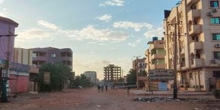 People walk on a street in southern Khartoum 