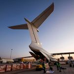 Workers load aid supplies from WHO