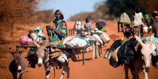 A woman rides a donkey Abyei