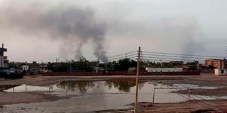 Smoke billows in the distance amid ongoing fighting in Khartoum