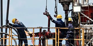 Workers at a crude oil extraction plant in Colombia.