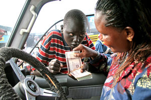 A motorist changes money from a boy in Juba, South Sudan