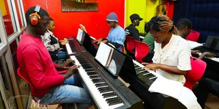 Music students practicing piano at Music And Film Academy, a leading music school in Nairobi.
