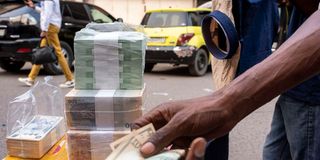 A currency trader in Kinshasa, DR Congo